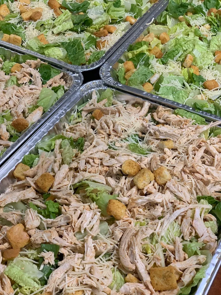 Catering pans of salad ready for pickup
